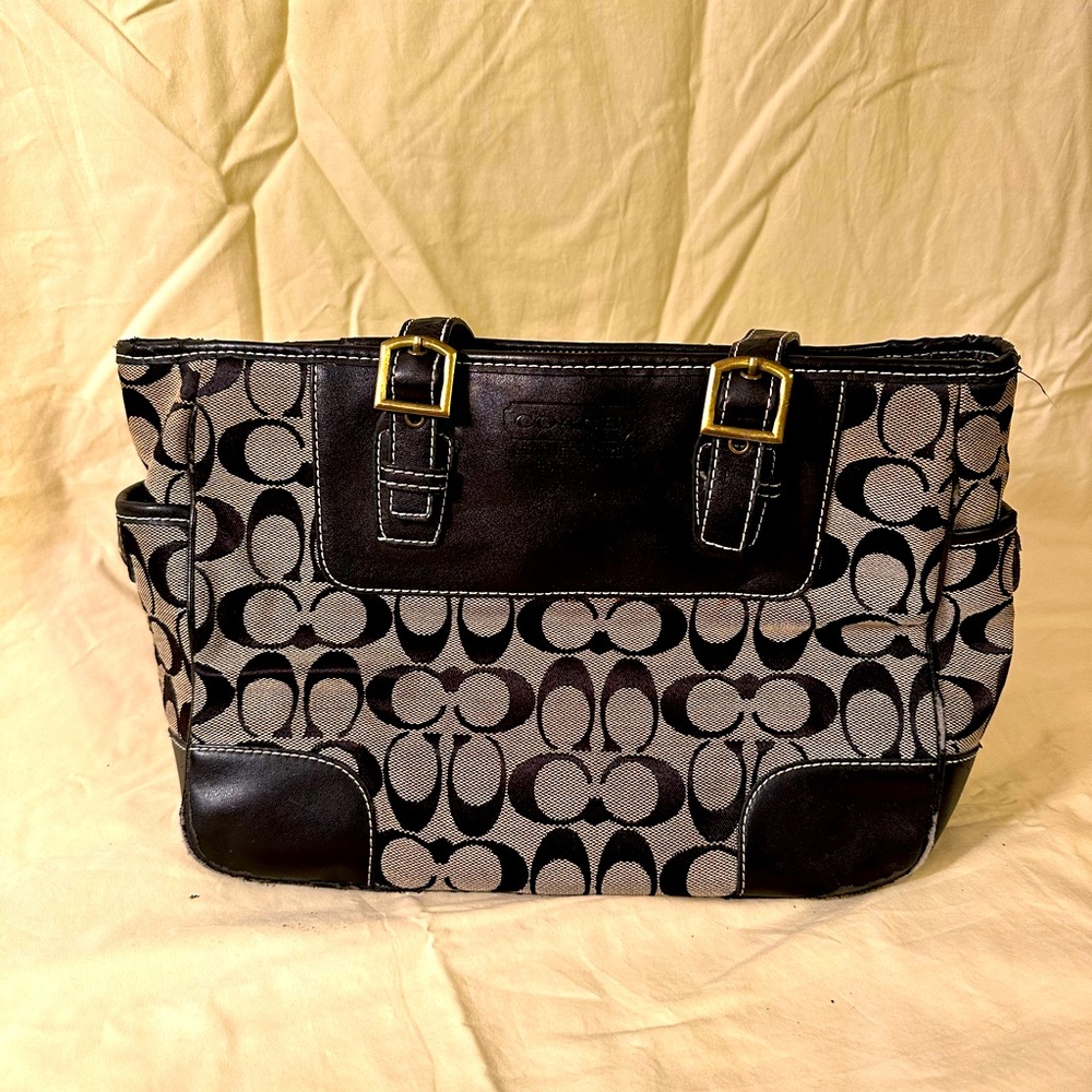 Coach purse Black and Tan. 12x9 with one main section with zipper /inside zipper